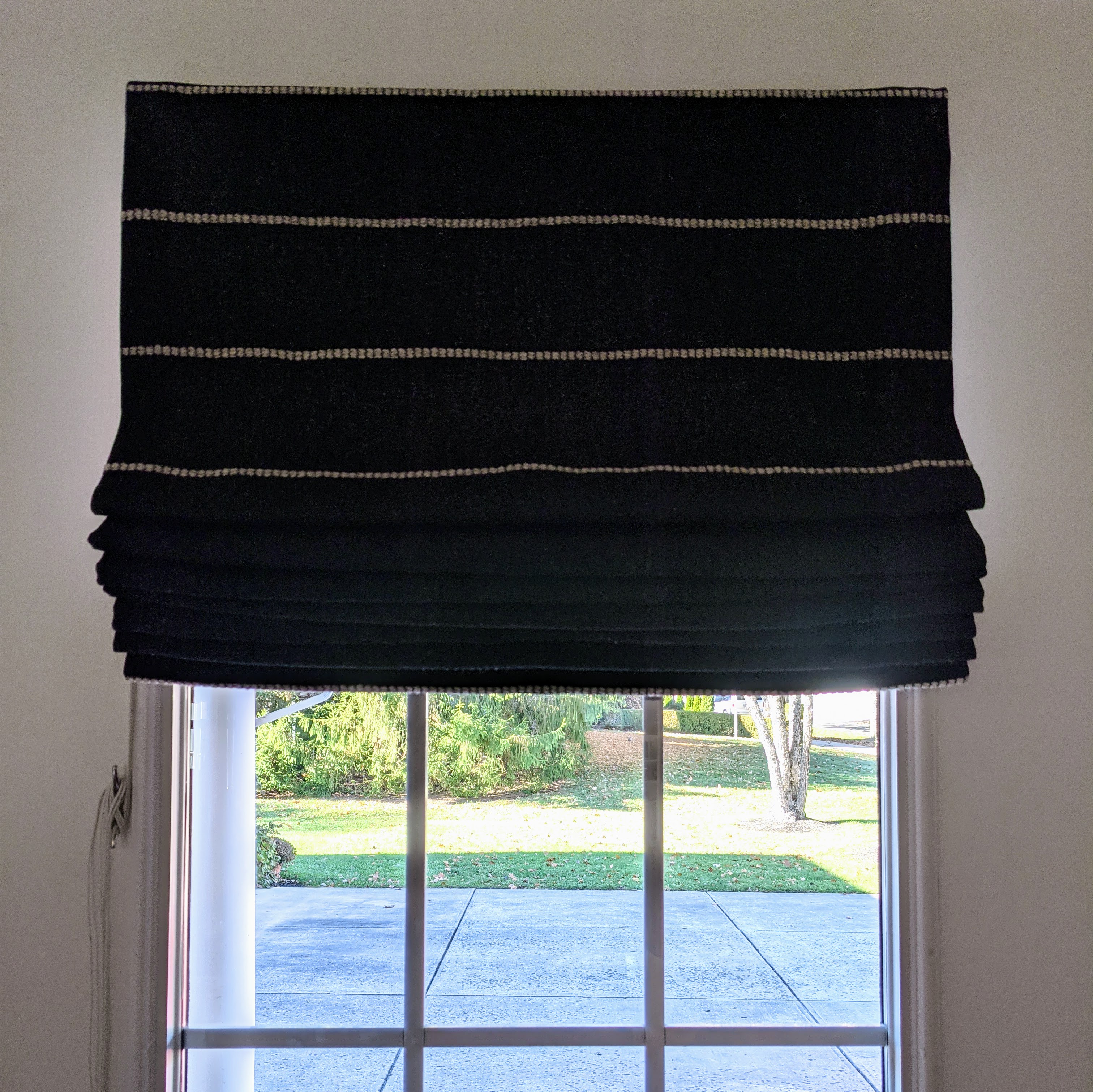 Custom handmade Roman shades by Artsy ALPS, showcasing elegant design and high-quality craftsmanship.